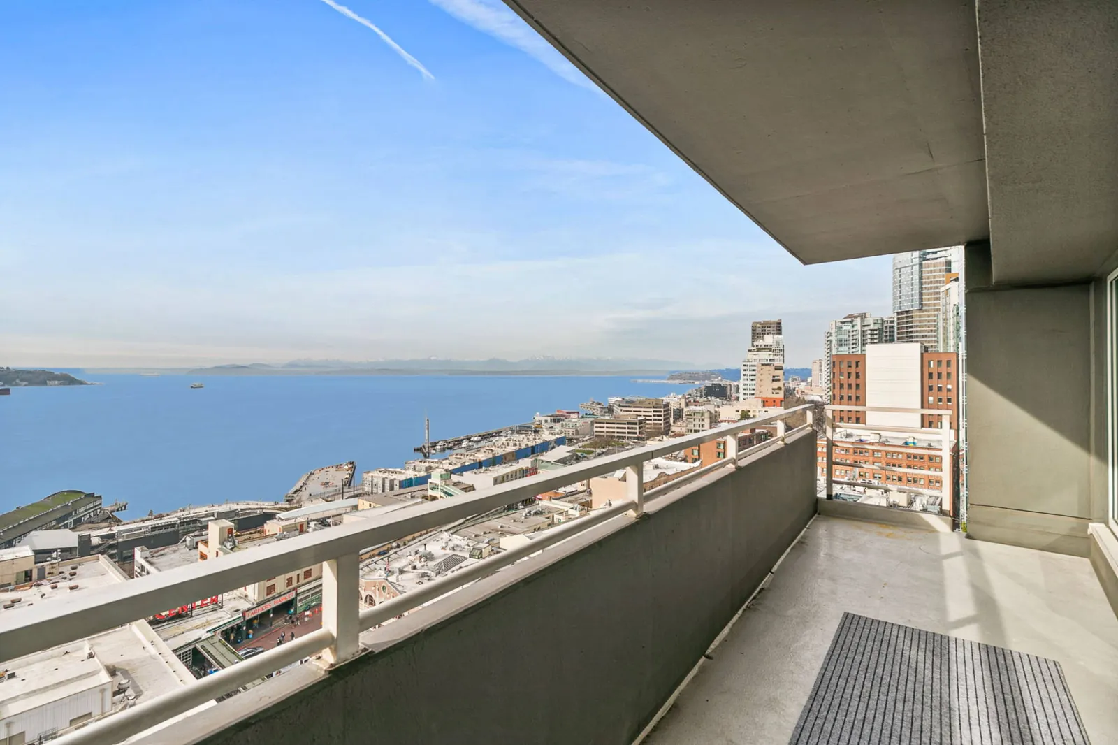 View from the OceanView condo balcony over Pike Place Market, Elliott Bay and the Olympic Mountains
