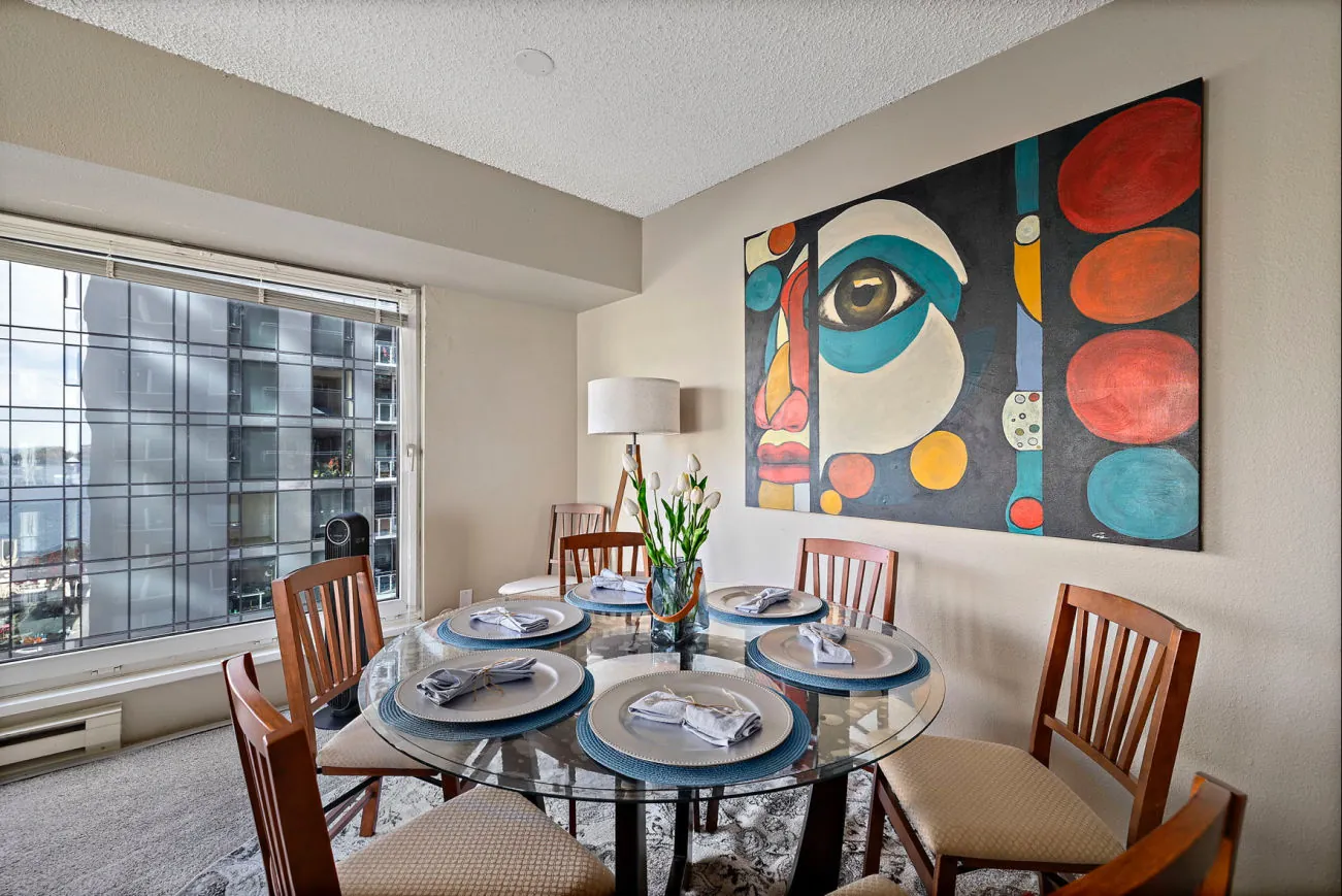 Dining table set for six at the Pike Place condo, beside a window over downtown Seattle