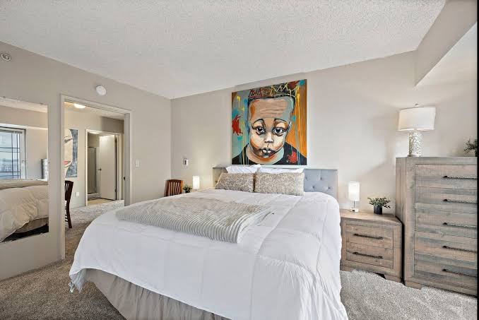 Pike Place Condo master bedroom with the second bedroom visible through the doorway
